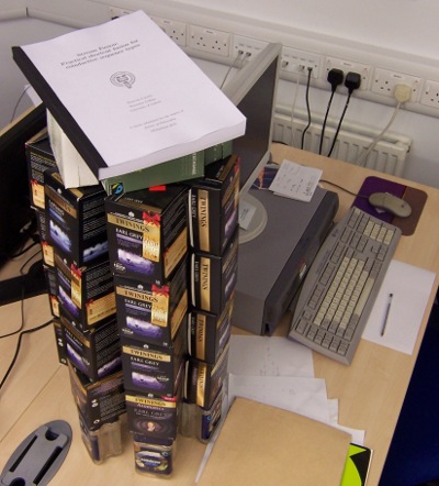 around 1.5kcot ('kcot' being the well-known unit '1k cups of tea') A PhD thesis on top of a big stack of empty tea boxes.